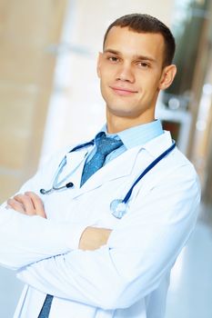 Portrait of friendly male doctor in hospital smiling