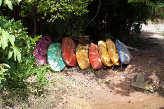 row of colorful boats on land