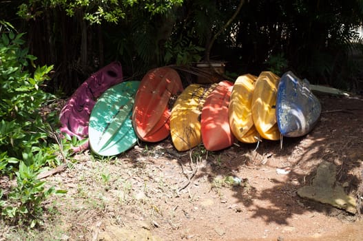 row of colorful boats on land