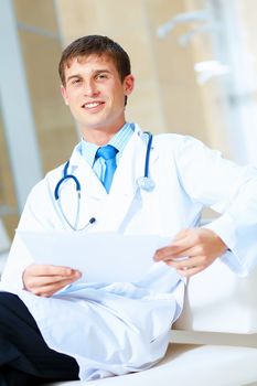 Portrait of friendly male doctor in hospital smiling