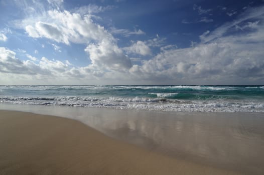 Landscape with sea and sand, white clouds in the sky