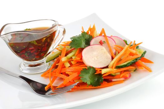 Salad of fresh carrots with the radish and cucumber

