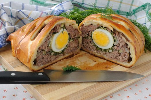 Sliced meatloaf with egg and herbs baked in pastry