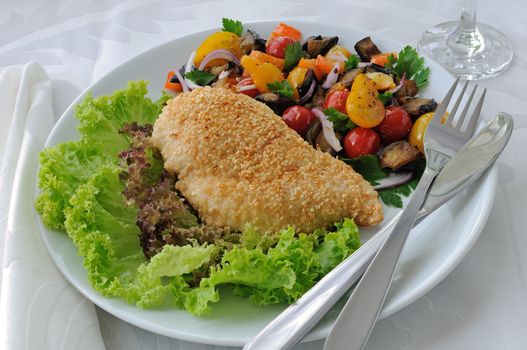 Chicken cutlet with eggplant in sesame with tomato and pepper