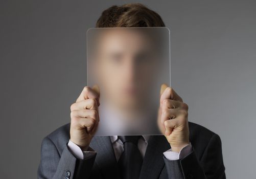 A Young business man covering his face