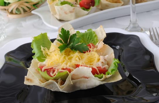 Chicken with tomatoes and cheese in a basket made of dough "phyllo"