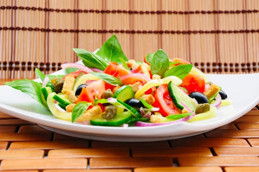 Fresh vegetable salad with basil, capers, olives, marinated with croutons