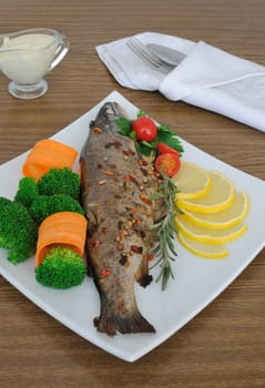 Baked sea bass in spices with broccoli and carrots