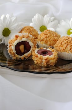 Cheese balls stuffed with cherries in peanuts