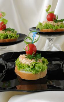 Mini sandwiches (canapés) with chicken in sesame