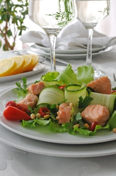 Vegetable salad with boiled salmon and pine nuts