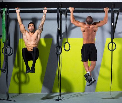 Crossfit toes to bar men pull-ups 2 bars workout exercise at gym