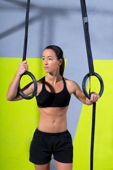 Crossfit dip ring woman relaxed after workout at gym dipping exercise