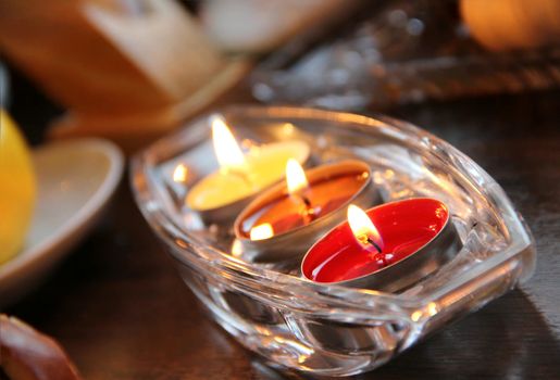 Three beautiful burning candles in the luxury crystal candlestick