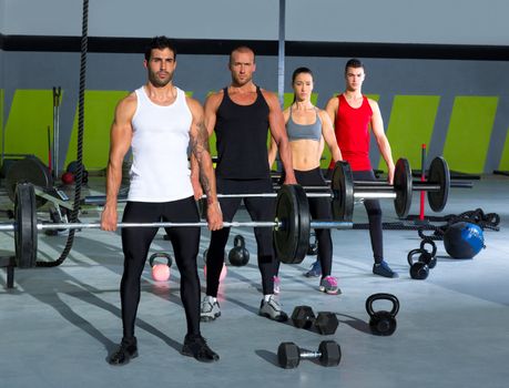 gym group with weight lifting bar workout in crossfit exercise