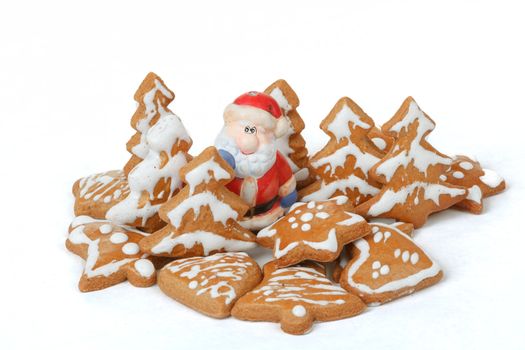 homemade christmas gingerbreads and ceramic santa on white background