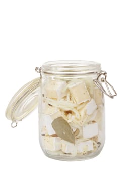 homemade spicy marinated cheese with oil, onion, garlic and spicy spices on white