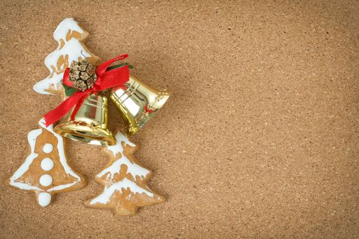 corc board with homemade ginger bread and christmas bells