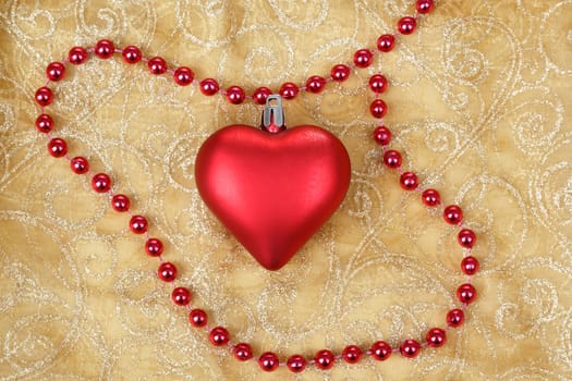 red heart with jewelery on christmas table cloth