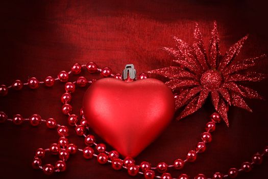 valentine heart with flower and jewelery on red background