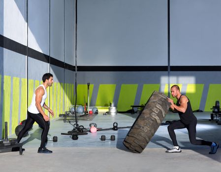 Crossfit flip tires men flipping each other the wheel workout