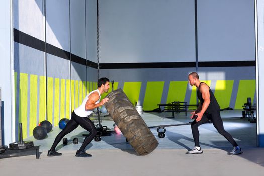 Crossfit flip tires men flipping each other the wheel workout