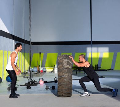 Crossfit flip tires men flipping each other the wheel workout