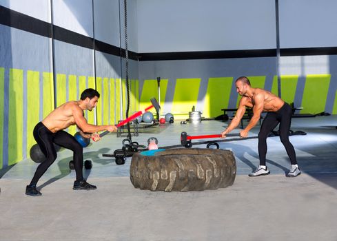 Crossfit sledge hammer men workout at gym