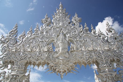 Buddha Sculpture at the entrance in famous buddhist White temple Wat Rong Khun, Chiang Rai, Thailand