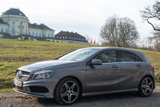 STUTTGART - NOVEMBER 21 : The new Mercedes Class A 250 AMG Sport is parked in front of Solitude Palace on November 21, 2012 in Stuttgart, Germany. The new A-Class is a complete makeover of the previous generations, the 250 AMG Sport is the largest version available, developed together with car tuner AMG.
