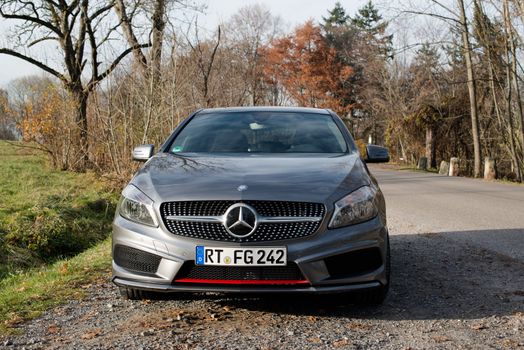 STUTTGART - NOVEMBER 21 : The new Mercedes Class A 250 AMG Sport is parked in front of Solitude Palace on November 21, 2012 in Stuttgart, Germany. The new A-Class is a complete makeover of the previous generations, the 250 AMG Sport is the largest version available, developed together with car tuner AMG.