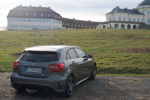 STUTTGART - NOVEMBER 21 : The new Mercedes Class A 250 AMG Sport is parked in front of Solitude Palace on November 21, 2012 in Stuttgart, Germany. The new A-Class is a complete makeover of the previous generations, the 250 AMG Sport is the largest version available, developed together with car tuner AMG.