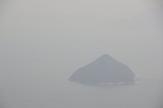 Island in Seto Inland Sea as seen from Miyajima on a foggy day in Japan