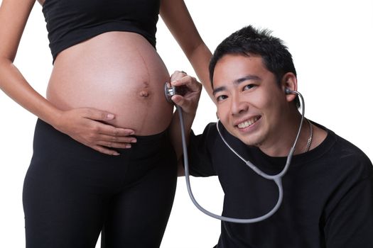 Young asian father with stethoscope. Listen to his heart baby