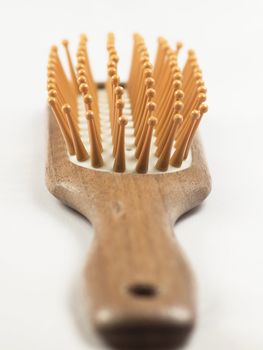 Wooden hair brush isolated on white background.