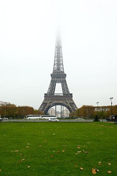 The Eiffel Tower with the top disappearing in the fog