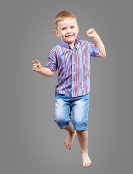 boy jumping hands up smiling and happy