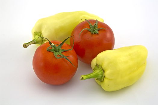 Peppers and tomatoes on a white background