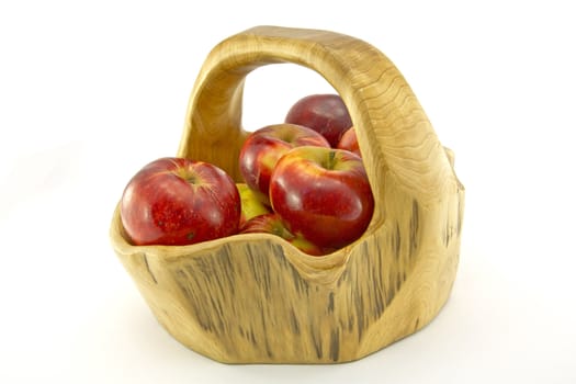 Shiny red apples in a wooden basket