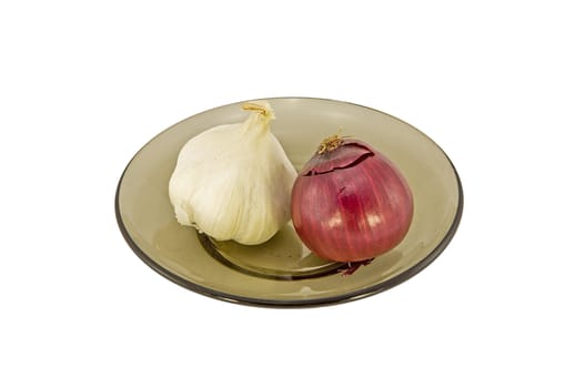 Garlic and red onion on a plate isolated on white