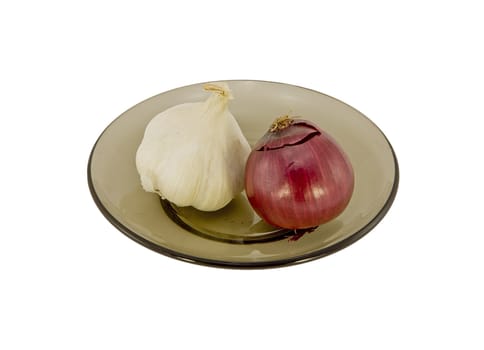 Two onions on a glass plate isolated on white