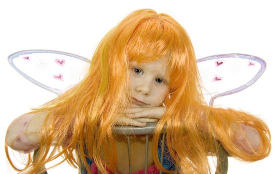 Girl in fancy dress and a wig on a white background