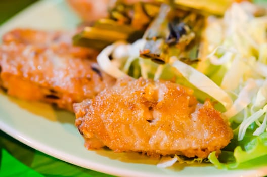 deep fried chicken with fried garlic  and fresh vegetable