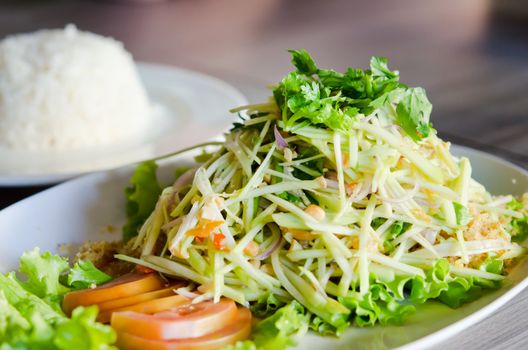 spicy crispy catfish salad with green mango and fresh vegetable served with rice