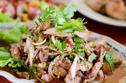 spicy slices pork on dish ,  mix vegetable  and chili sauce