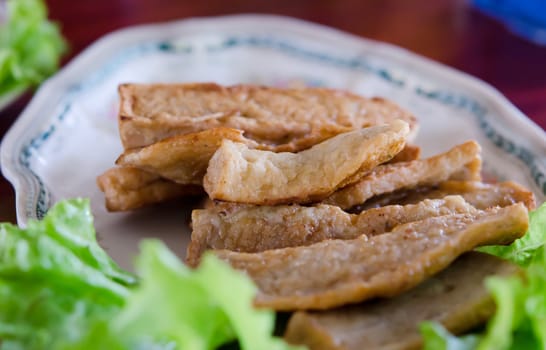 fried vietnamese sausage served with fresh vegetable on dish