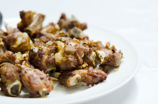 fried pork spare ribs with garlic and pepper on plate