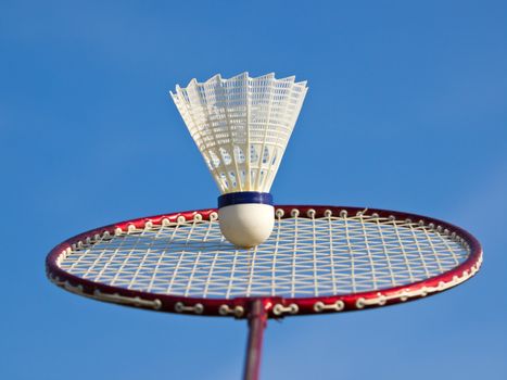 badminton racket and ball under the blue sky