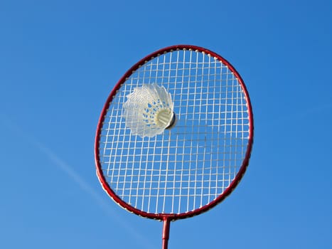 badminton racket and ball under the blue sky