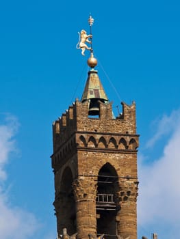 tower of church with golden lion in Florence Italy